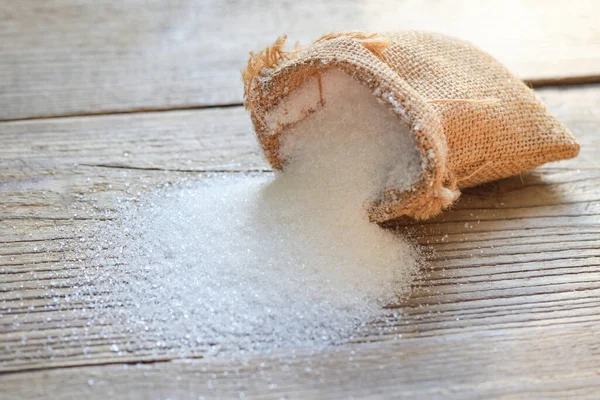 Sugar sack on wooden background, white sugar for food and sweets dessert candy heap of sweet sugar crystalline granulated