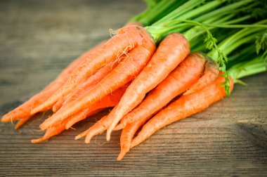 carrot on wooden table background, Fresh and sweet carrots for cooking food fruits and vegetables for health concept, baby carrots bunch and leaf