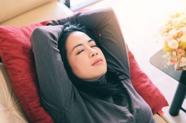 sleeping on the sofa woman relaxing sleeping on couch at home, relaxed serene pretty young woman feel fatigue lounge on comfortable sofa rest at home, happy calm lady dream enjoy wellbeing take a rest