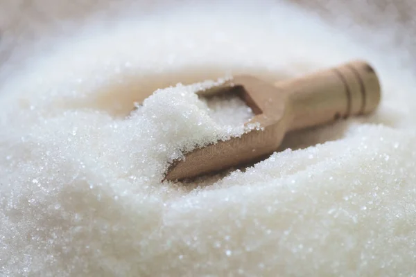 Sugar on wooden scoop, white sugar for food and sweets dessert candy heap of sweet sugar crystalline granulated
