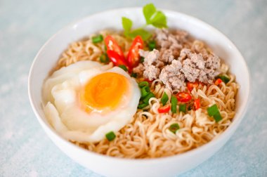 noodles bowl with boiled egg minced pork vegetable spring onion lemon on table food , instant noodles cooking tasty eating with bowl noodle soup - top view