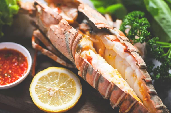 stock image spiny lobster food on plate, fresh lobster or rock lobster seafood with herb and spices lemon coriander parsley lettuce salad, lobster for cooking food and seafood sauce