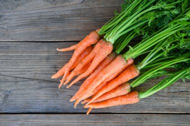 carrot on table background, Fresh and sweet carrots for cooking food fruits and vegetables for health concept, baby carrots bunch and leaf