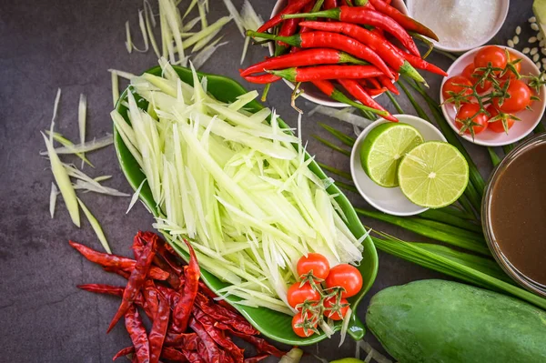 stock image Thai food top view - papaya salad spicy with herbs and spices condiments and ingredients with chili tomato lemon lime papaya Slice, Thai Food Concept