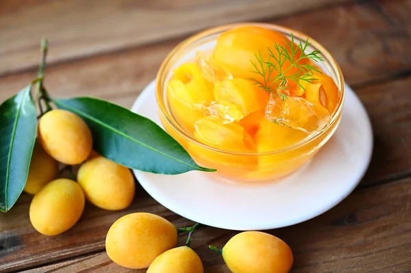 stock image Sweet dessert marian plum fruit  on bowl for food and wooden background, tropical fruit Name in Thailand sweet Yellow Marian Plum Maprang Plango or Mayong chid