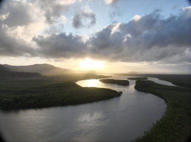 Sunrise over a meandering river mouth. Located in the Daintree River, Queensland clipart