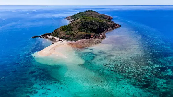 Etrafı resiflerle çevrili küçük tropikal adanın havadan görünüşü. Queensland, Townsville yakınlarındaki Acheron Adası. 