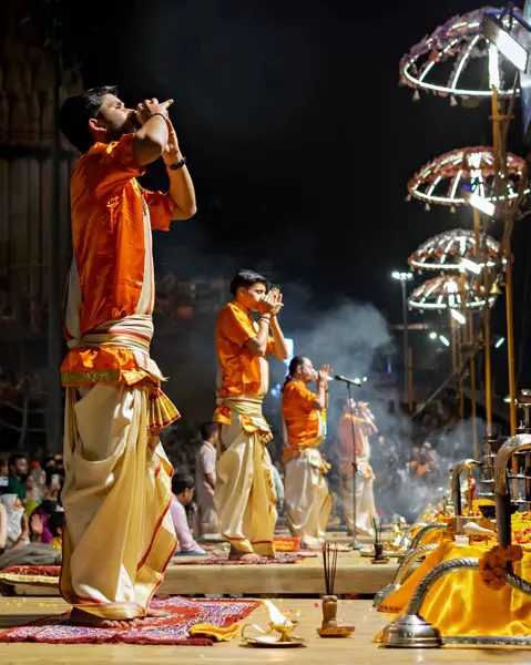 stock image Varanasi, Uttar Pradesh, India - March 21st, 2024: Priests performing Ganga aarti on banks of holy river Ganges in one of the oldest living cities of World and spiritual capital of India, Varanasi.