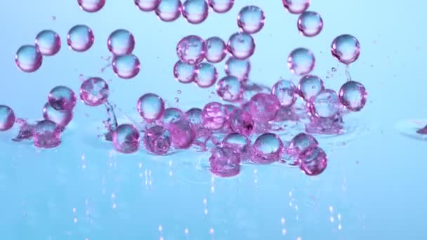 Super Slow Motion Shot Neon Hydrogel Balls Booning Glass Water — стоковое видео