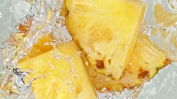 Super Slow Motion Shot Pineapple Slies Falling Water Whirl 1000 — стоковое видео