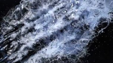 Super Slow Motion shot of Splashing Water on Black background on 1000 fps. 4K 'da yüksek hızlı sinema kamerası ile çekildi...