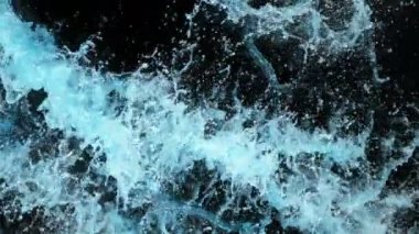 Super Slow Motion shot of Splashing Water on Black background on 1000 fps. 4K 'da yüksek hızlı sinema kamerası ile çekildi...