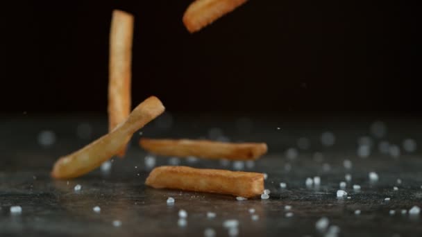 Super Slow Motion Shot Falling Fresh French Fries Black Table — Αρχείο Βίντεο