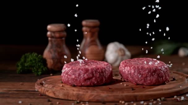 Super Slowmotion Footage Strewing Salt Fresh Raw Beef Meat Burger — Stock Video