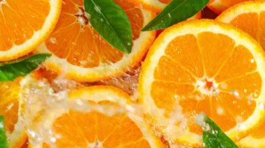 Turuncu Dilimlere Sıçrayan Suyun Süper Yavaş Çekimi. 4K 'de Yüksek Hız Sinema Kamerası ile çekildi..