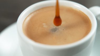 Düşen damlalar süper yavaş bir kahvenin içine düşüyorlar. 4K, 1000fps 'de yüksek hızlı sinema kamerasıyla çekildi..