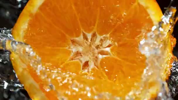 Super Slow Motion Detail Shot Rotating Fresh Orange Slice Splashing — Stok Video
