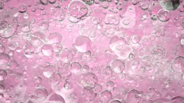 Super Slow Motion Shot Oil Bubbles Pupping Water Pingk Graham — стоковое видео
