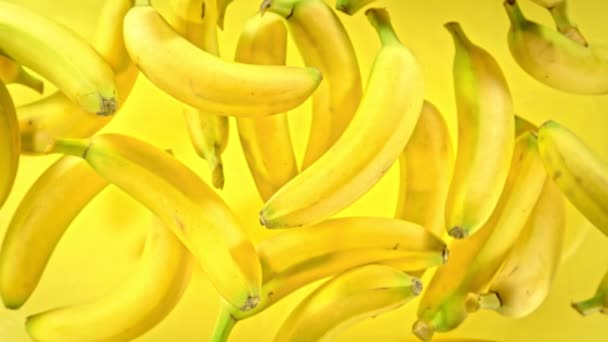Super Slow Motion Shot Plátanos Frescos Sobre Fondo Amarillo Volando — Vídeo de stock