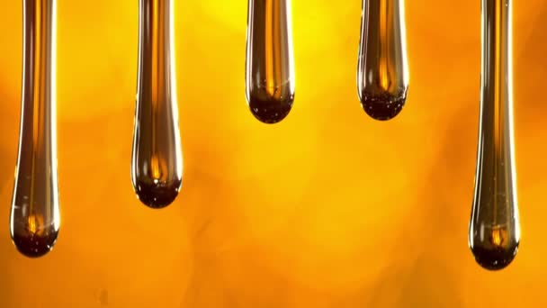 Super Slow Motion Macro Shot Dripping Oil Golden Background 1000 — Video