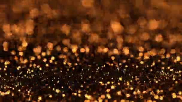 超慢速运动的金光抛射颗粒在黑色背景下1000 Fps分离 — 图库视频影像