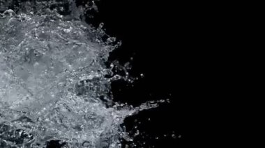 Super Slow Motion Shot of Real Side Water Splash Explosion on Black Background at 1000fps. Filmed on high speed cinema camera in 4k..