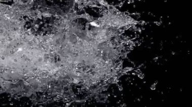 Super Slow Motion Shot of Real Side Water Splash Explosion on Black Background at 1000fps. Filmed on high speed cinema camera in 4k..