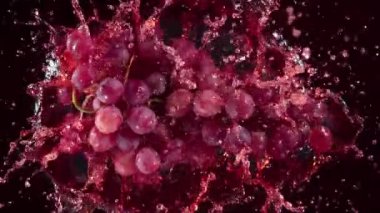 Super Slow Motion Shot of Fresh Grape Falling into Red Wine on Black Background at 1000 fps. Filmed with High Speed Cinema Camera in 4K.