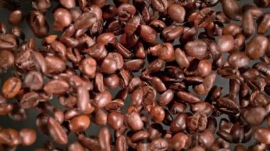 Super Slow Motion Shot of Coffee Beans Explosion Towards Camera with Camera Rotation at 1000fps. Filmed with High Speed Cinema Camera in 4k.