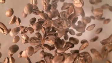 Super Slow Motion Shot of Coffee Beans and Smoke Explosion Towards Camera with Camera Rotation at 1000fps. Filmed with High Speed Cinema Camera in 4k.