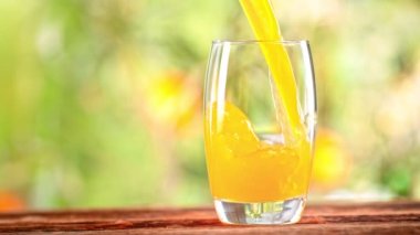 Super Slow Motion Shot of Pouring Fresh Orange Juice into Glass at 1000 fps. Filmed with High Speed Cinema Camera in 4k.