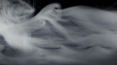 Super Slow Motion Shot of Abstract Flowing Smoke Isolated on Black at 1000fps. Filmed on high speed cinema camera in 4k..