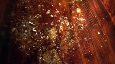 Super Slow Motion Detail Shot of Splashing Whiskey in Old Oak Barrel at 1000fps. Filmed with High Speed Cinema Camera at 4K