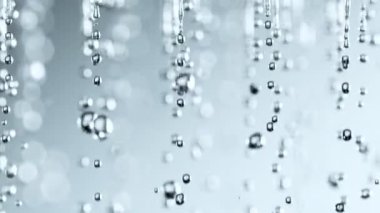 Super Slow Motion Shot of Various Water Drops Falling on Light Grey Background at 1000fps. Filmed with High Speed Cinema Camera at 4K.