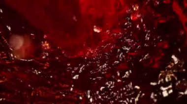 Super Slow Motion Macro Shot of Pouring Red Wine into Whirl at 1000 fps. Shooted with High Speed Cinema Camera in 4K.