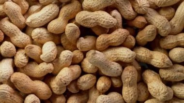 Super Slow Motion Detail Shot of Rotating Peanuts at 1000 fps. Filmed with High Speed Cinema Camera at 4K.