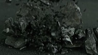 Super Slow Motion Shot of Falling Coal and Black Powder at 1000 fps. Filmed with High Speed Cinema Camera in 4K Resolution.