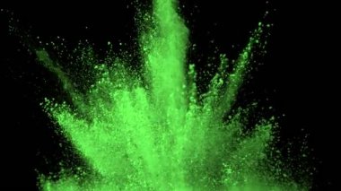 Super Slow Motion Shot of Green Powder Explosion Isolated on Black Background at 1000fps. Shooted with High Speed Cinema Camera at 4K.