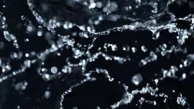 Super Slow Motion Shot of Water Splashing on Black Background at 1000fps. Filmed with High Speed Cinema Camera at 4K Resolution.