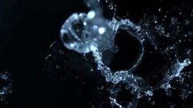 Super Slow Motion Shot of Splashing Water on Black Background at 1000fps. Filmed on High Speed Cinema Camera in 4K Resolution.