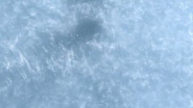 Super Slow Motion Shot of Glitters Glittering in Water on Blue Background at 1000 fps. Filmed with High Speed Cinema Camera at 4K.