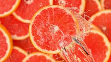 Super Slow Motion Shot of Splashing Water on Rotating Grapefruit Slice at 1000fps. Shooted with High Speed Cinema Camera at 4K.
