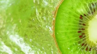 Super Slow Motion Shot of Splashing Water from Rotating Kiwi Slice at 1000fps. Shooted with High Speed Cinema Camera at 4K.