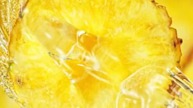 Super Slow Motion Shot of Splashing Water on Rotating Pineapple Slice at 1000fps. Shooted with High Speed Cinema Camera at 4K.