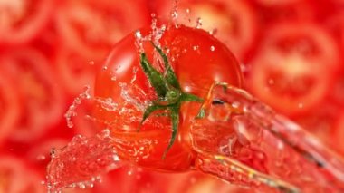 Super Slow Motion Shot of Splashing Water on Rotating Tomato at 1000fps Shooted with High Speed Cinema Camera at 4K.