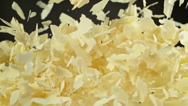 Super Slow Motion Shot Flying Parmesan Shavings Black Background 1000 — стоковое видео