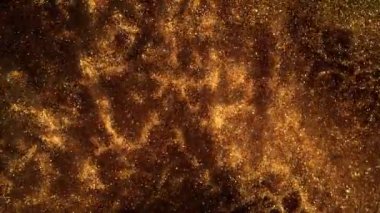 Super Slow Motion Shot of Golden Glittering Particle Background on Black at 1000fps. Filmed with High Speed Cinema Camera in 4K Resolution.