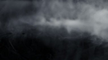 Super Slow Motion Shot of Abstract Flowing Smoke Isolated on Black at 1000fps. Filmed on high speed cinema camera in 4k..