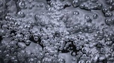 Super Slow Motion Shot of Oil Bubbles in Blue Water at 1000fps. Filmed with High Speed Cinema Camera at 4K.