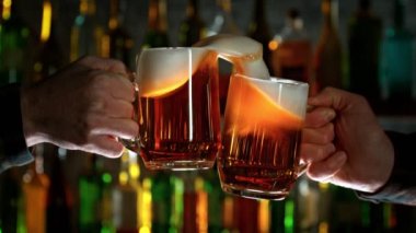 Super Slow Motion Shot of Beer Glasses Cheering in Bar at 1000fps. Filmed with High Speed Cinema Camera, 4K.